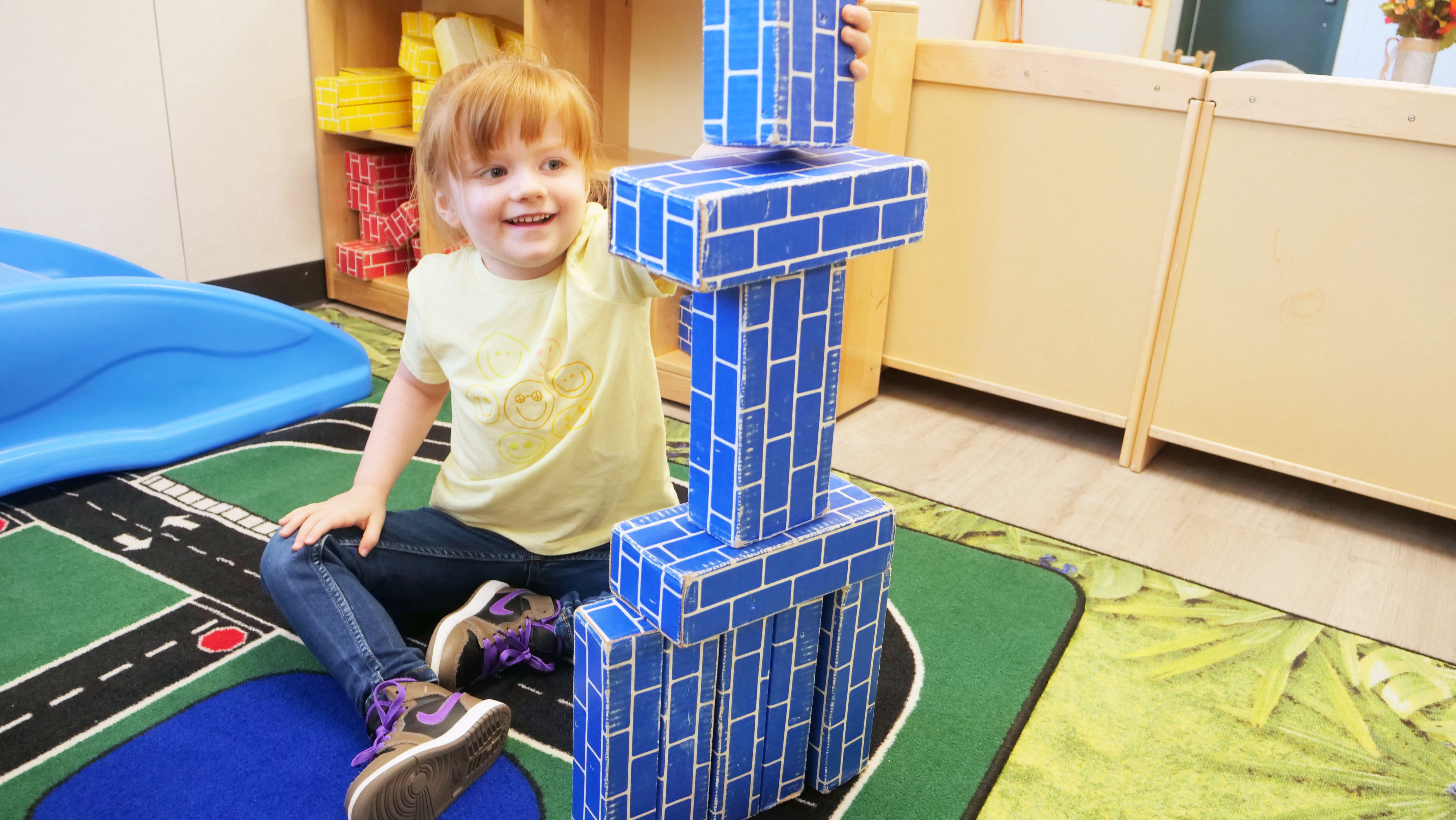 child playing with blocks on floor