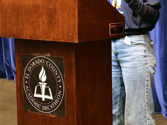 student reading essay at podium