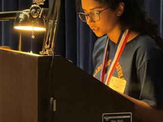 student reading essay at podium