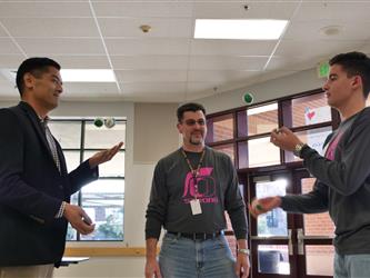 Ed Manansala and Coach Hussein playing hacky sack with a student