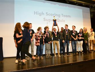 winners holding up trophy