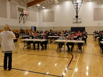 students testing in gymnasium
