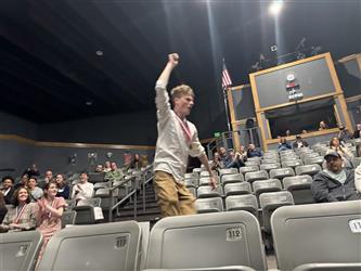student walking to stage