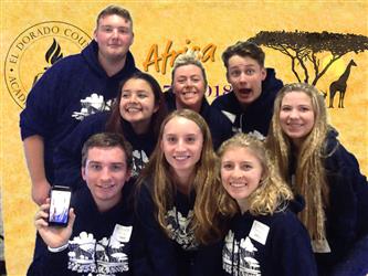 team posing with zoom background