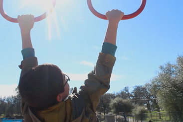boy holding on swing